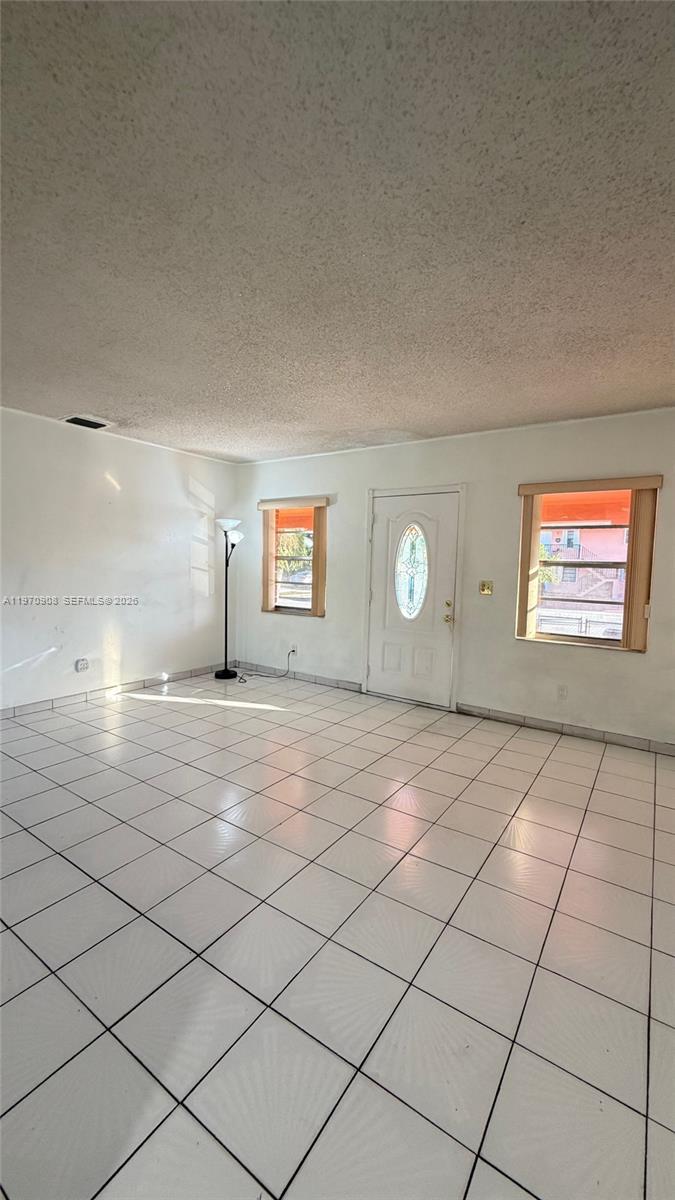 309 East 18th Street Hialeah, FL 33010 - Photo 4 of 15 a view of a livingroom with wooden floor and a window