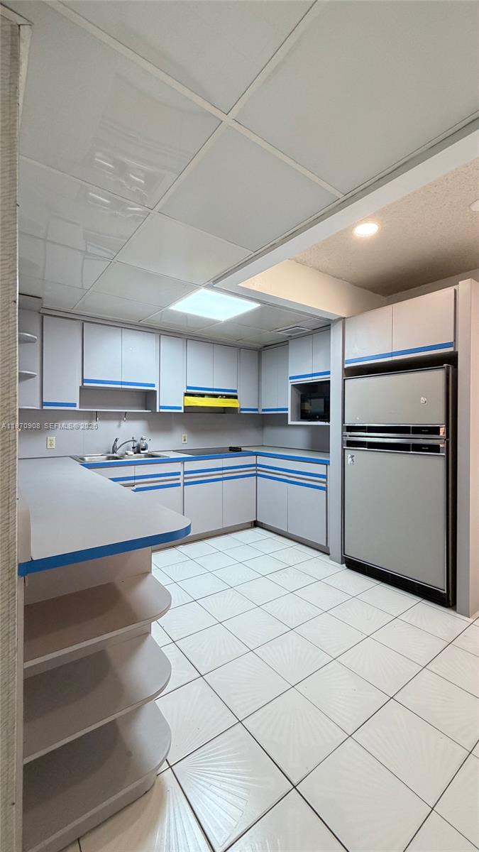 309 East 18th Street Hialeah, FL 33010 - Photo 8 of 15 a kitchen with granite countertop a refrigerator and cabinets
