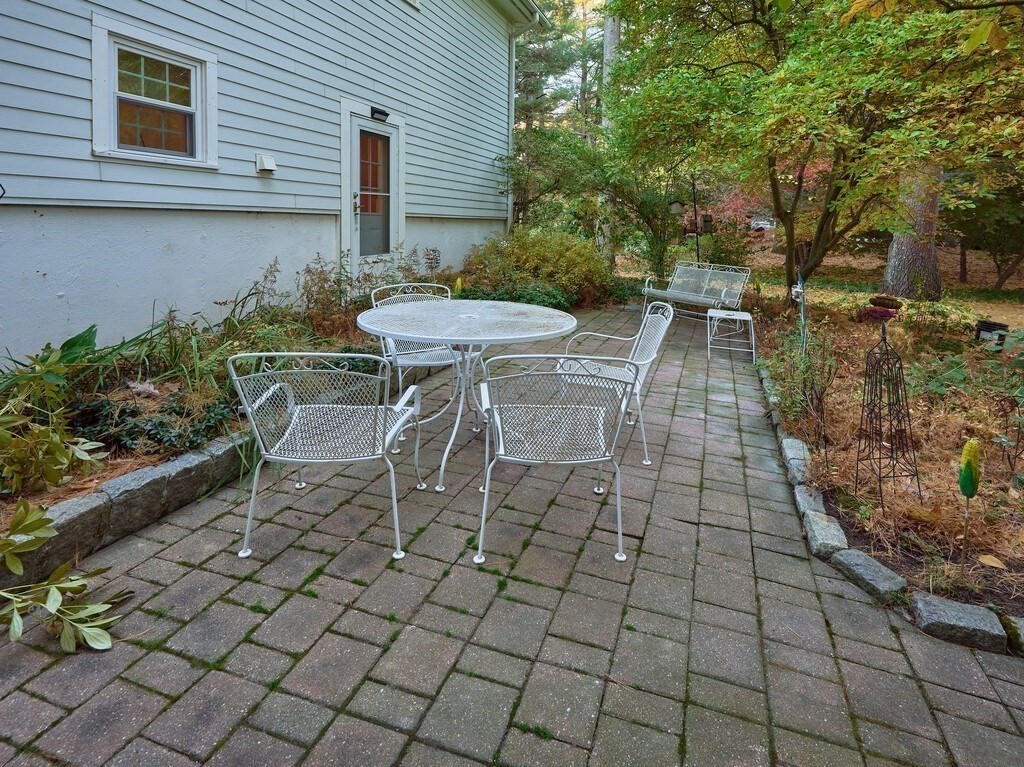 6 Holbrook Road Wayland, MA 01778 - Photo 19 of 23 a view of a patio with table and chairs with wooden fence and plants