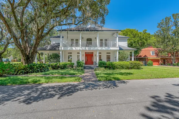 a building with potted plants in front of door