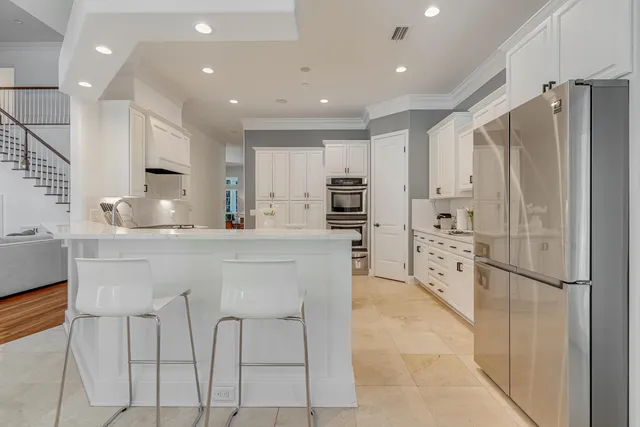 a spacious bedroom with a bed and a refrigerator