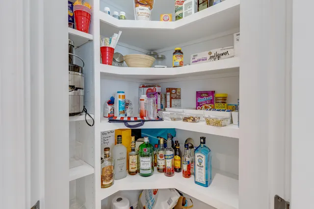 a view of a hallway with wooden floor and windows
