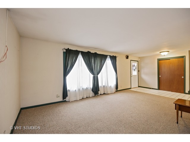 18530 Bock Road Lansing, IL 60438 - Photo 2 of 20 a view of empty room with wooden floor and window