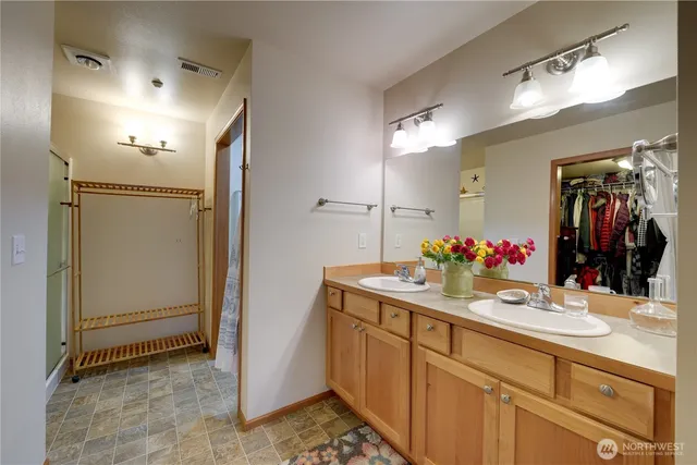 a bathroom with a sink vanity and a mirror