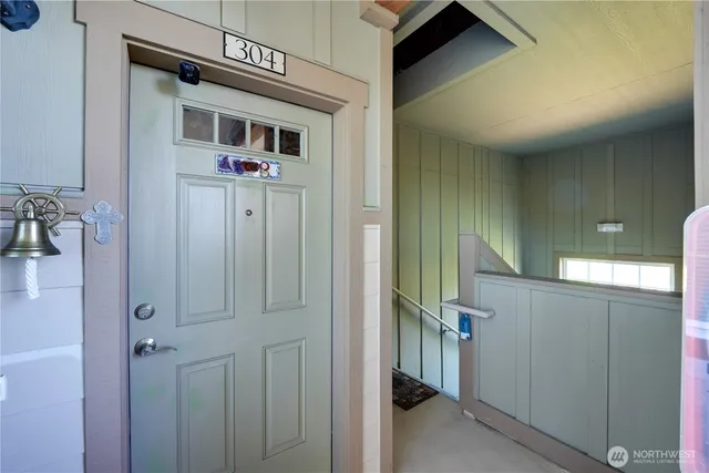 a view of a hallway with wooden walls