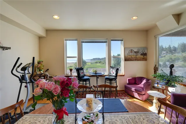 a living room with furniture a rug and a large window