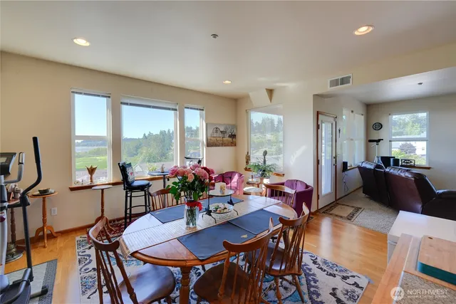 a view of a dining room with furniture and a potted plant