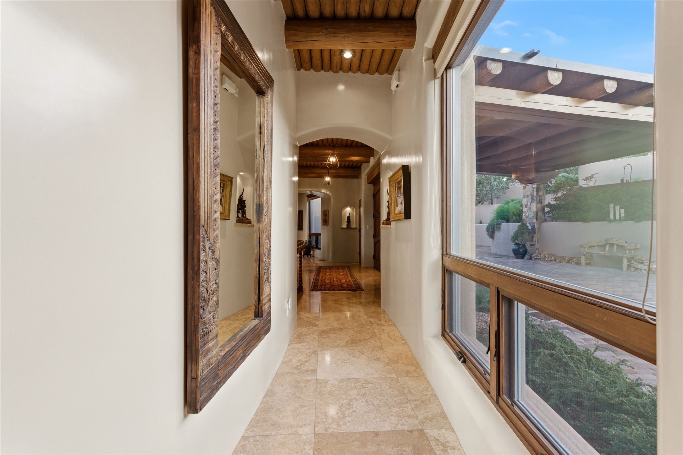 42 San Juan Ranch Road Santa Fe, NM 87506 - Photo 16 of 49 Spacious Hall with large windows connects all rooms. Spacious openings for main living areas increases natural light and openness of home