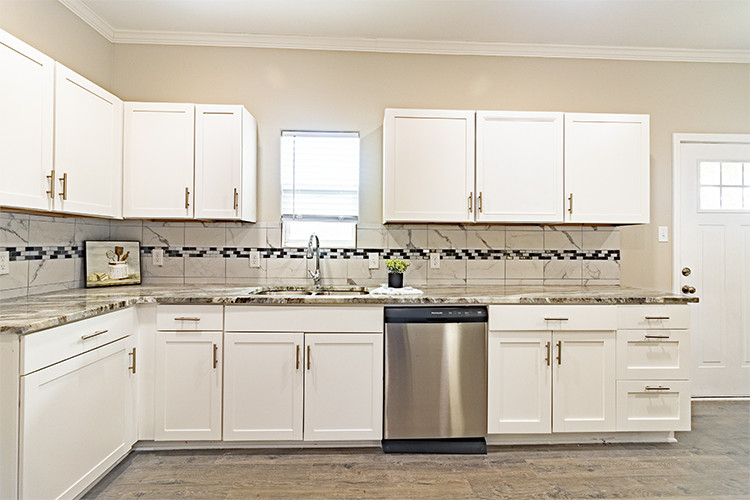 803 Hall Street Bryan, TX 77803 - Photo 5 of 11 a kitchen with granite countertop white cabinets and white appliances