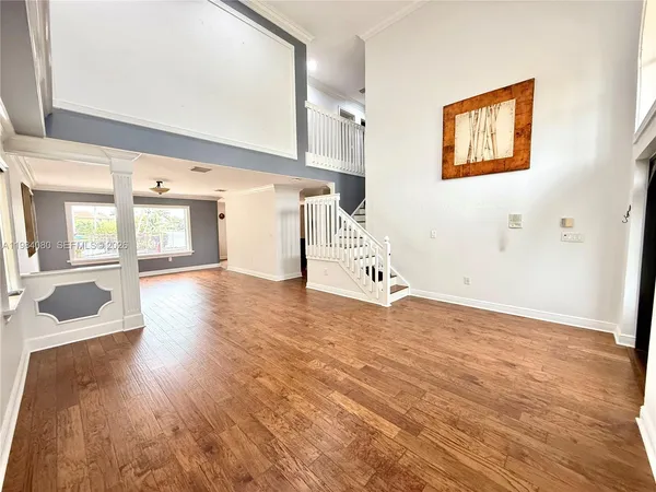 a room with furniture pool table and windows
