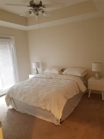a large bed sitting in a bedroom next to a window