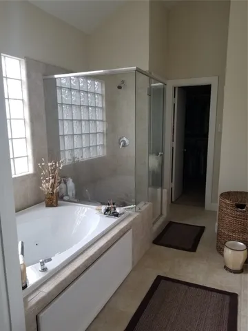 a living room with a bed and a chandelier