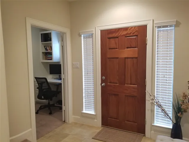 a view of hallway with closet and a bathroom