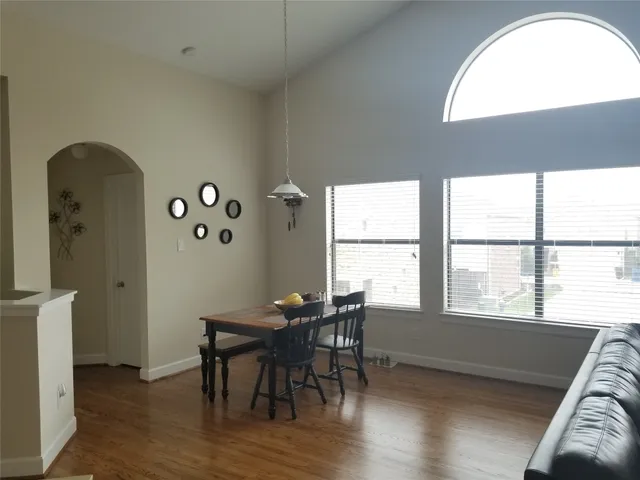 a view of a dining room with furniture and a window
