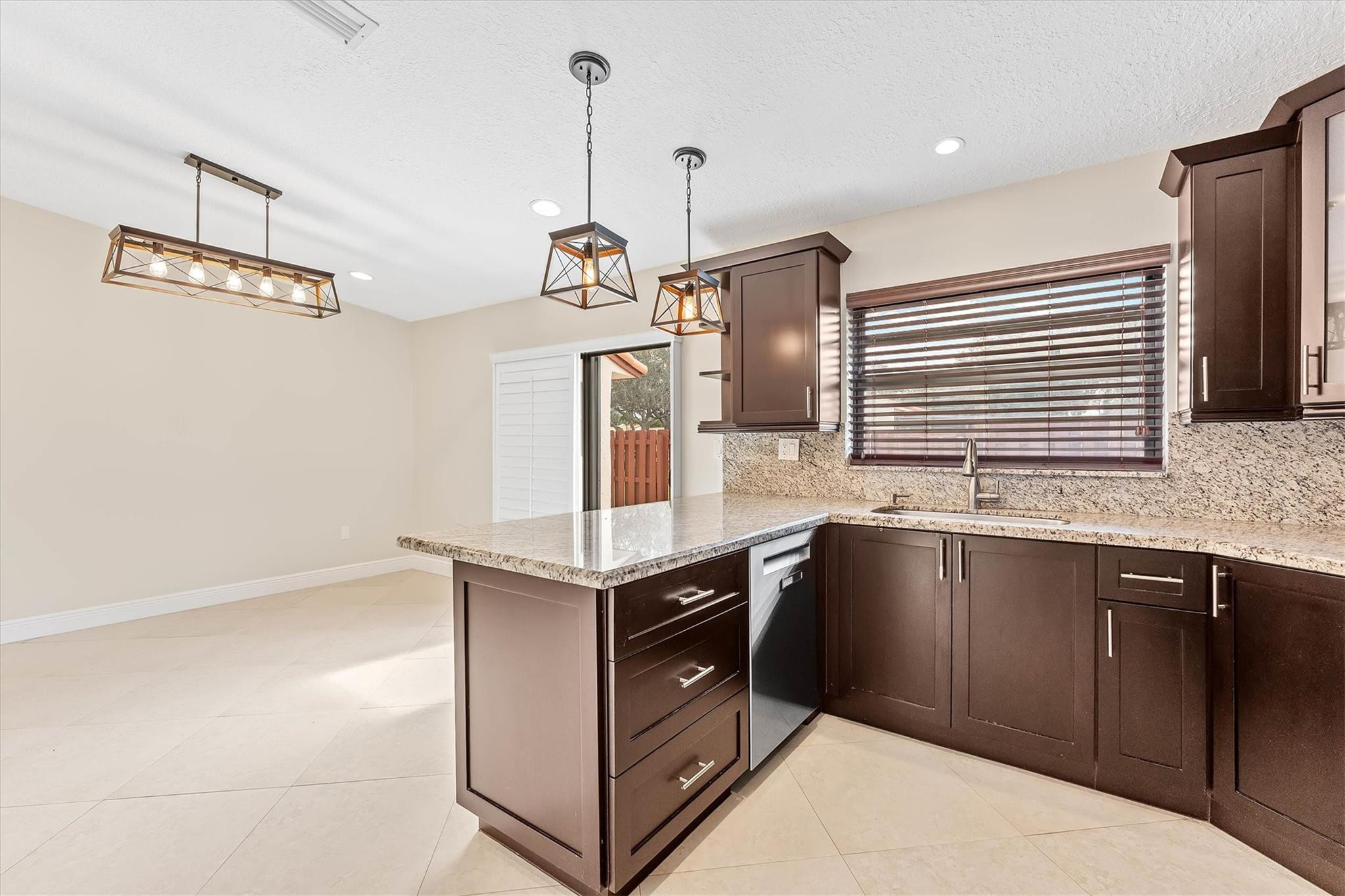 11288 Southwest 59th Court Cooper City, FL 33330 - Photo 11 of 32 a kitchen with stainless steel appliances granite countertop a sink and a stove