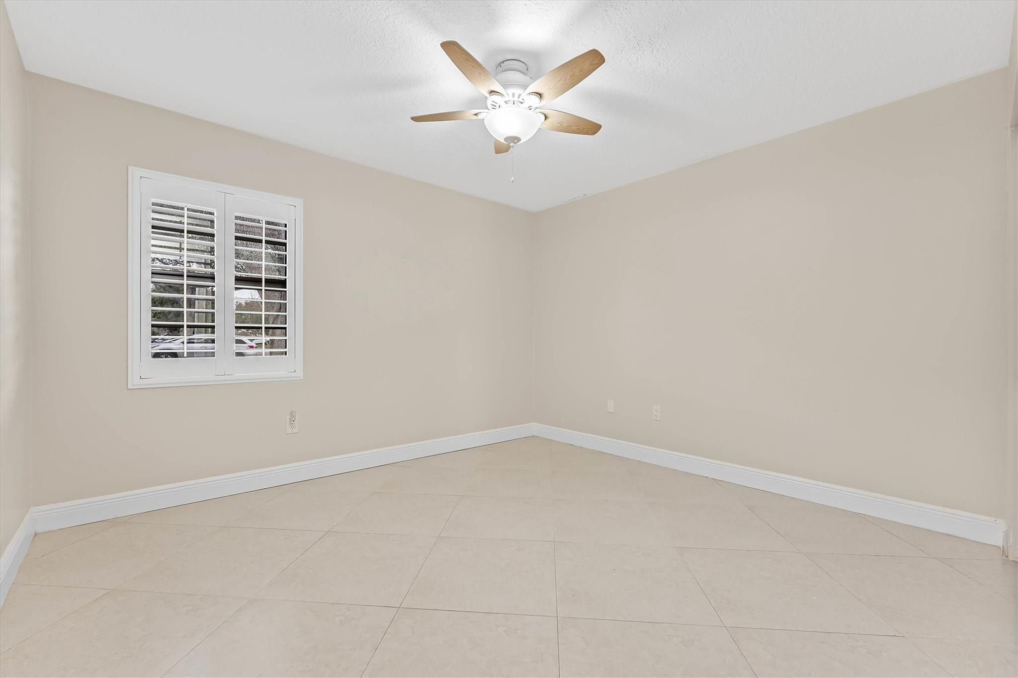 11288 Southwest 59th Court Cooper City, FL 33330 - Photo 13 of 32 an empty room with windows and fan