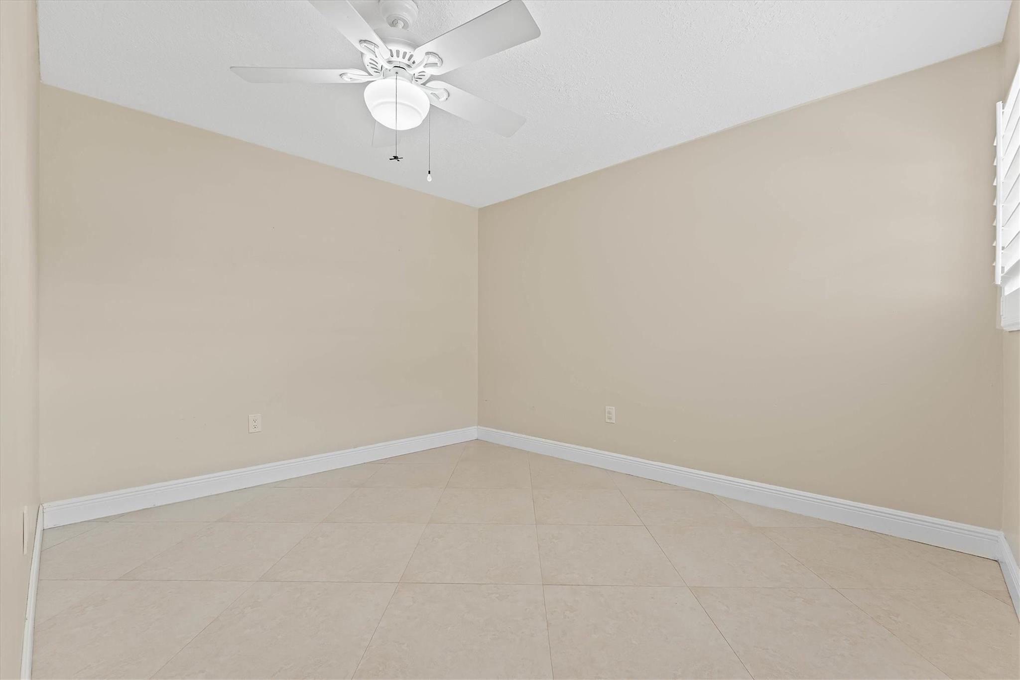 11288 Southwest 59th Court Cooper City, FL 33330 - Photo 17 of 32 an empty room with a fan & a window