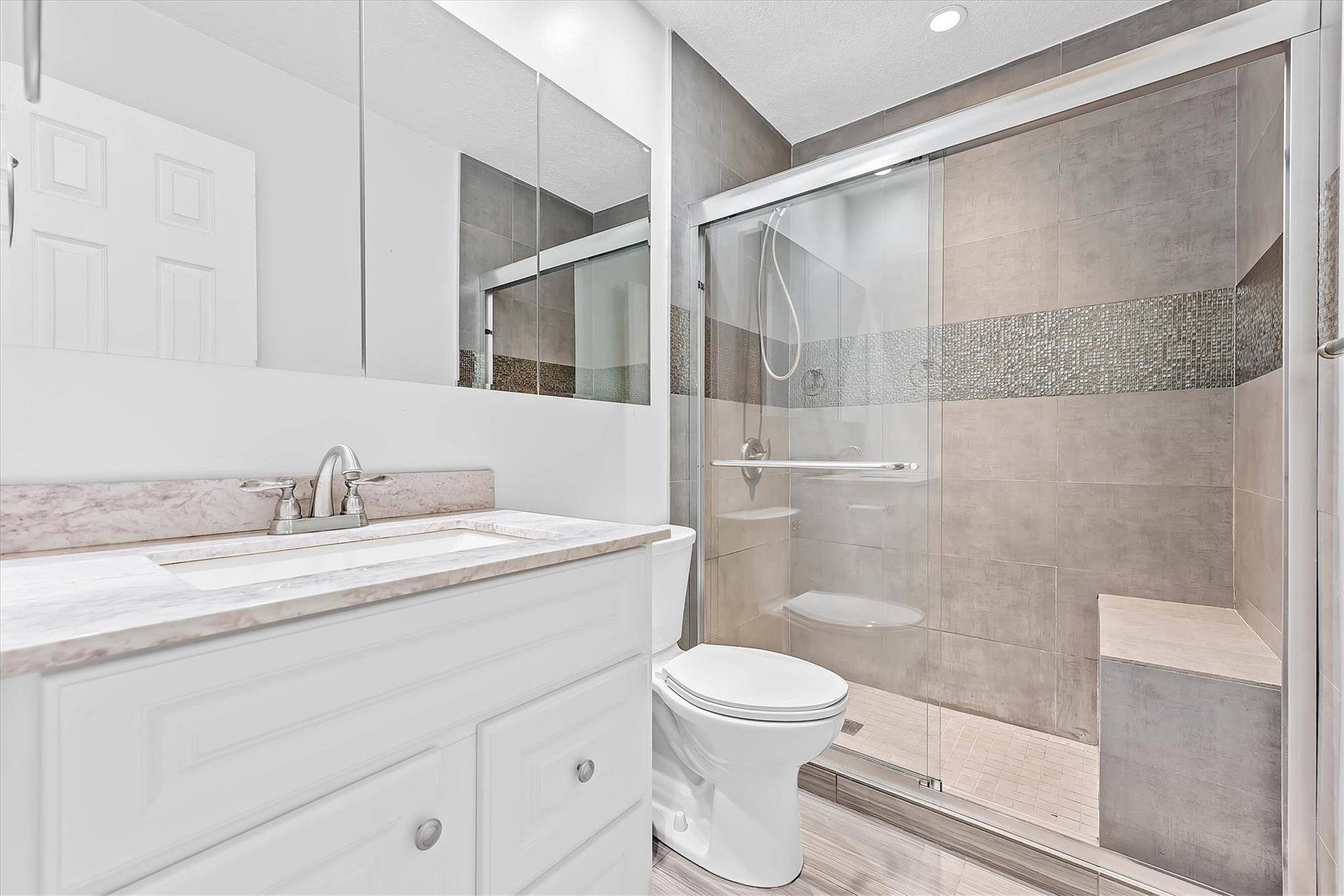11288 Southwest 59th Court Cooper City, FL 33330 - Photo 20 of 32 a bathroom with a granite countertop sink toilet and shower