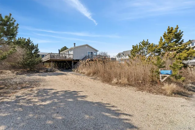 a view of a dry yard with wooden fence