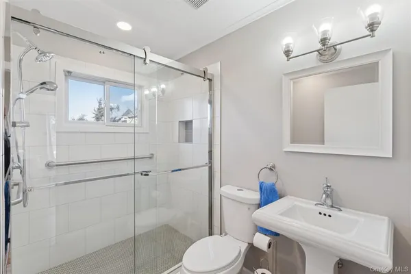 a bathroom with a sink toilet and shower