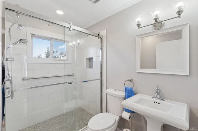 a bathroom with a sink toilet and shower