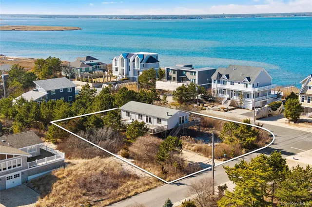 a view of swimming pool with outdoor seating and ocean view