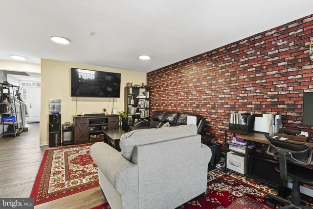 a kitchen with stainless steel appliances granite countertop a sink refrigerator and cabinets