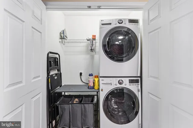 a kitchen with stainless steel appliances granite countertop a sink a stove and a wooden floor