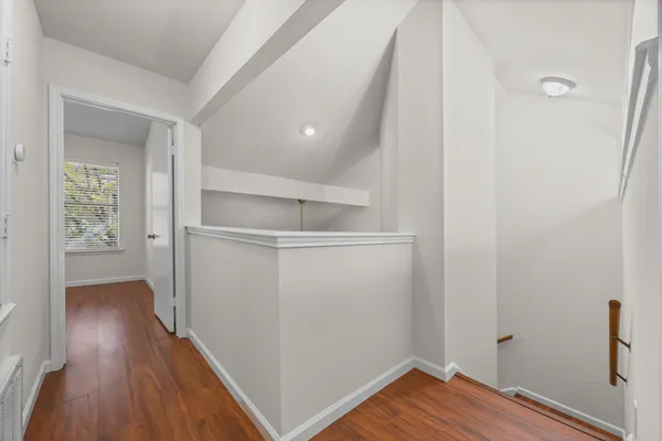 a view of a room with wooden floor