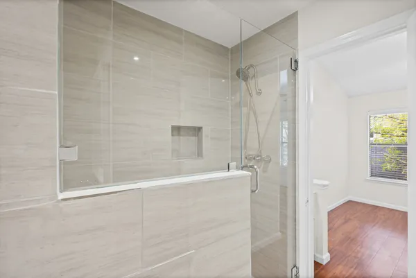 a bathroom with a bathtub and shower