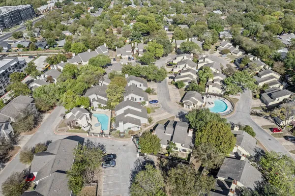 an aerial view of a residential houses with outdoor space