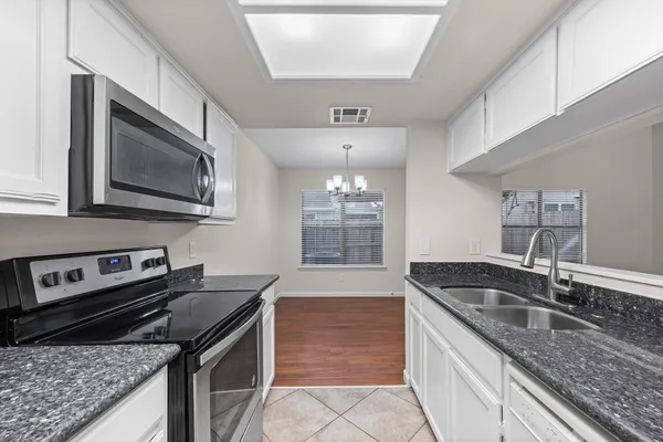 a kitchen that has a sink and a stove