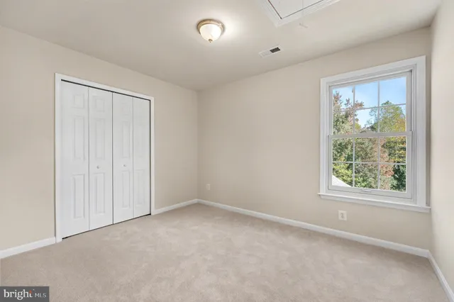 a bathroom with a granite countertop sink a toilet and a mirror