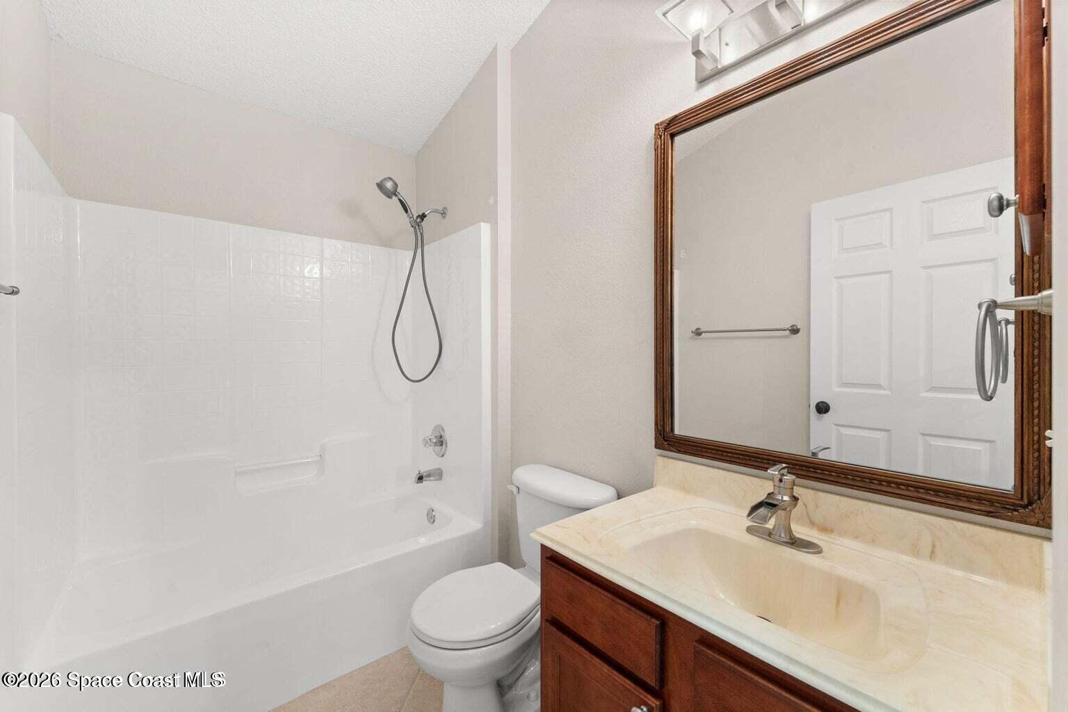 4741 Decatur Circle Melbourne, FL 32934 - Photo 22 of 44 a bathroom with a sink toilet vanity and shower