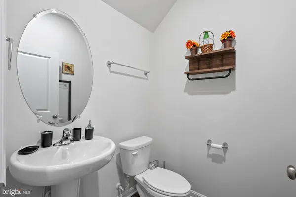 a bathroom with a sink a mirror and toilet