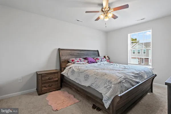 a bed sitting in a bedroom next to a window