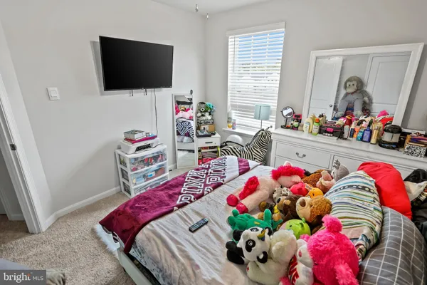 a bedroom with furniture and a flat screen tv