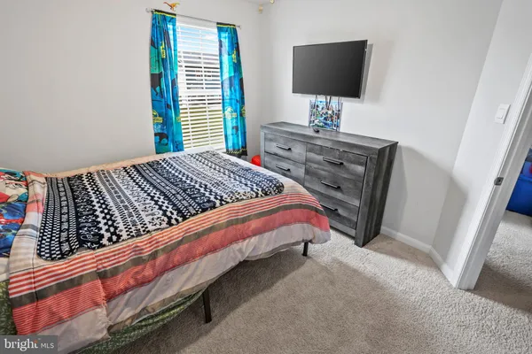 a bedroom with a bed and flat screen tv