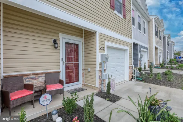 a view of backyard with outdoor seating and stairs