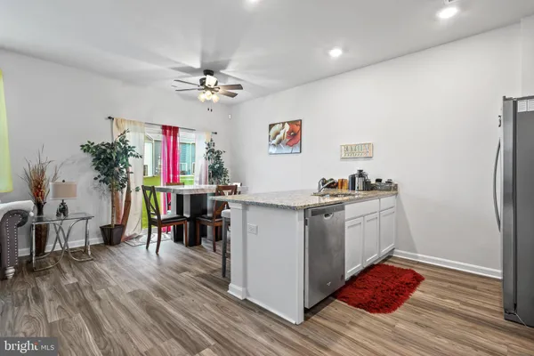 a kitchen with a refrigerator and white cabinets