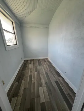 an empty room with wooden floor
