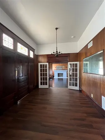 a view of a room with wooden floor