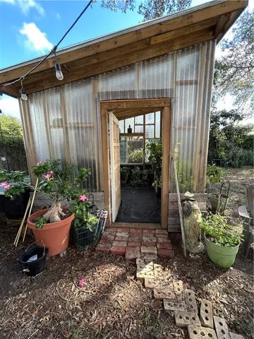 a view of a backyard with potted plants