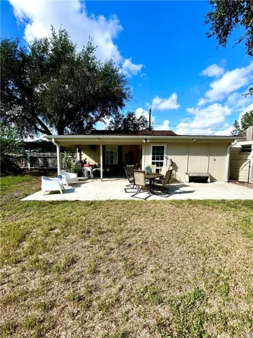 a swimming pool with outdoor seating and yard
