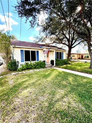 a front view of house with yard and green space