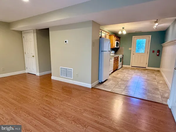 a view of a kitchen with wooden floor