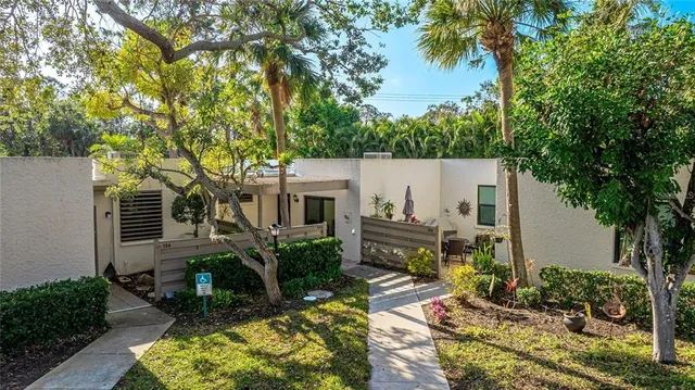 a view of backyard with a table and chairs and potted plants