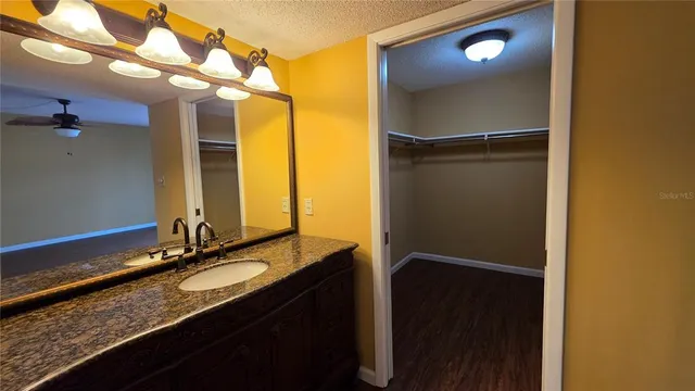 a bathroom with a double vanity sink and a mirror