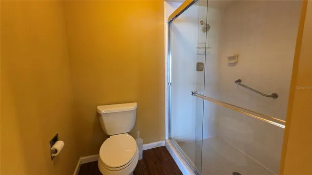 a white toilet sitting next to a bathroom sink