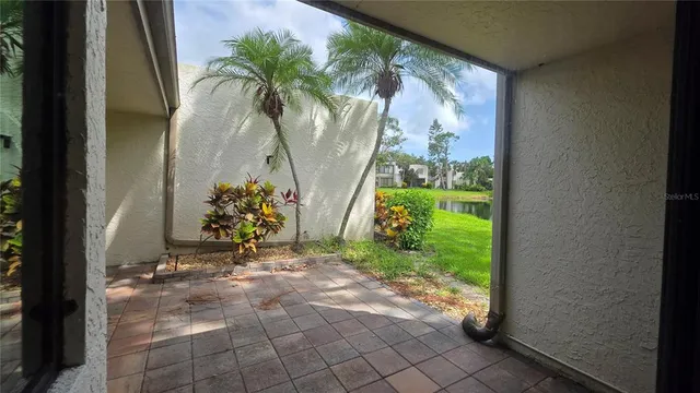 a view of a glass door with a yard in back